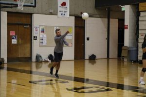Collin Smith Serving in volleyball class 